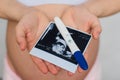 Ultrasound picture and positive pregnancy test in the hands of a pregnant girl Royalty Free Stock Photo