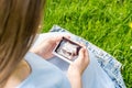 Ultrasound picture pregnant baby photo. Woman holding ultrasound pregnancy image on grass flower background. Concept of Royalty Free Stock Photo