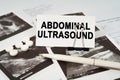 On the ultrasound pictures there is a pen and a business card with the inscription - Abdominal ultrasound