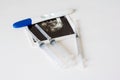 Ultrasound scan of baby and pregnancy test on white background Royalty Free Stock Photo