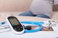 Ultrasound shot, stethoscope and glucose meter, pregnant woman on sofa, blood sugar control concept Royalty Free Stock Photo