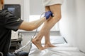 Ultrasound specialist scans veins on a woman& x27;s leg