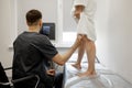 Ultrasound specialist scans veins on a woman& x27;s leg