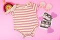 ultrasound (USG) results in sheets and baby clothes with boho rainbow on pink background