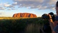 Uluru, Northern Territory, Australia 02/22/18. A photographer taking a shot of the ever changing colours of Uluru at sunset from Royalty Free Stock Photo