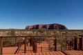 Uluru at sunrise under beautiful blue sky and the view platform, Uluru-Kata Tjuta National Park, Northern Territory, Australia