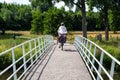 Ulvenhout, North Brabant, The Netherlands, Cyclist driving a bridge over the River Mark