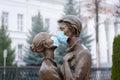 Ulyanovsk, Russia - December, 2020: A sculpture of two young people in coronavirus infection protection masks, covid masks, close