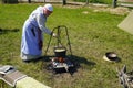 Ulyanovsk, Russia - July 16, 2022: Woman cooking food on fire in a pot. Historical reconstruction. Middle Ages