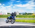 Ulyanovsk, Russia - June 10, 2017. Girl in a black jacket race on a blue motorcycle on a sports track.