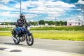 Ulyanovsk, Russia - June 10, 2017. Girl in a black jacket race on a blue motorcycle on a sports track.