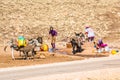 Um Er-Rbia, Morocco - October 15, 2013. Berber women collecting water to barells with donkeys