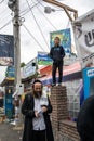 Uman, Ukraine, 13.09.2015: man in Kippah with a beard is walking on the street with lots of signboards written in Hebrew