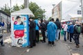 Uman,Ukraine, 13.09.2015: A lot of Jewish men in Kippahs and black clothes are walking on the dirty street with lots of garbage af