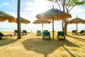 umbrella and beach chair with coconut palm tree and sea beach background and blue sky Royalty Free Stock Photo