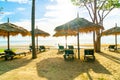 umbrella and beach chair with coconut palm tree and sea beach background and blue sky Royalty Free Stock Photo