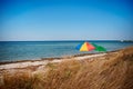 Umbrella on the beach with cloudy blue sky in background Royalty Free Stock Photo