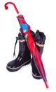 Umbrella on the black children rain boots Royalty Free Stock Photo