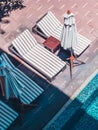 Umbrella and chair around luxury outdoor swimming pool