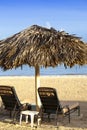 Umbrella and chaise lounges on a beach Royalty Free Stock Photo