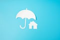 Umbrella cover Home paper on blue background. Warranty, Maintenance, real estate and insurance concept