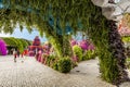 Umbrella-covered decorative alley on the territory of the botanical Dubai Miracle Garden in Dubai city, United Arab Emirates
