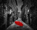 Umbrella on dark street in an old Italian town in Tuscany, Italy. Raining. Royalty Free Stock Photo