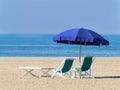 Umbrella with deck chairs and sun lounger on the beach Royalty Free Stock Photo