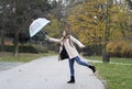 Umbrella flew to the side due to high winds.Girl with long hair.