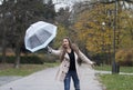 The umbrella flew to the side due to high winds.A young girl with long hair.