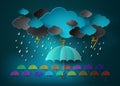 Umbrella with heavy fall rain in the dark sky