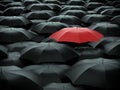 Umbrella over many black umbrellas