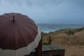 Umbrella from the rain close-up view from behind. Landscape the ocean in the storm Royalty Free Stock Photo