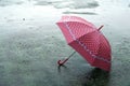 Umbrella on rainy day - The raindrops falling on an umbrella which put on the ground and copy space, feeling lonely and sad Royalty Free Stock Photo