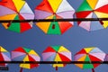 Several open umbrellas with blue sky.