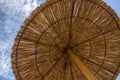 Umbrella from the sun from the reeds on the beach against the sky Royalty Free Stock Photo