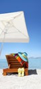 Umbrella and sunbed on the beach with blue hat, flip flop Royalty Free Stock Photo