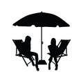 Umbrella with two chair for beach and girls silhouette Royalty Free Stock Photo