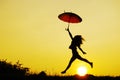 Umbrella woman jump and sunset