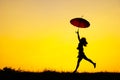 Umbrella woman jump and sunset silhouette Royalty Free Stock Photo