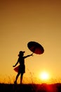 Umbrella woman jump and sunset silhouette Royalty Free Stock Photo