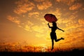 Umbrella woman jump and sunset silhouette Royalty Free Stock Photo