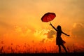 Umbrella woman jump and sunset silhouette Royalty Free Stock Photo