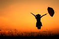 Umbrella woman jump and sunset silhouette Royalty Free Stock Photo