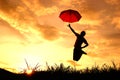 Umbrella woman jump and sunset silhouette in Lake Royalty Free Stock Photo