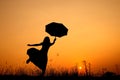 Umbrella woman jumping and sunset silhouette Royalty Free Stock Photo