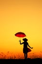 Umbrella woman jumping and sunset silhouette Royalty Free Stock Photo