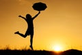 Umbrella woman jumping and sunset silhouette Royalty Free Stock Photo