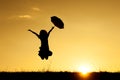 Umbrella woman jumping and sunset silhouette Royalty Free Stock Photo