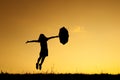 Umbrella woman jumping and sunset silhouette Royalty Free Stock Photo